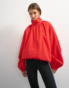 Model wearing Pleated funnel neck anorak in red
