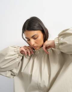 Model wearing Pleated funnel neck anorak in stone