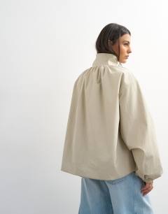 Model wearing Pleated funnel neck anorak in stone