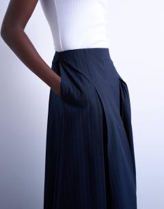Model wearing Pleated midi skirt in navy with rust stripe