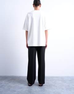 Model wearing Pleated straight leg trouser in black 