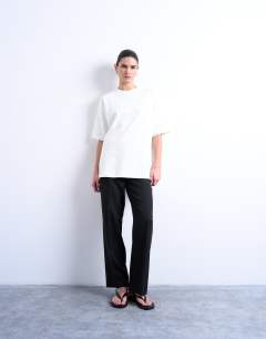 Model wearing Pleated straight leg trouser in black 