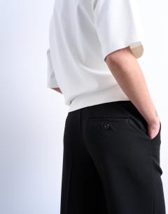 Model wearing Pleated straight leg trouser in black 