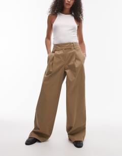 Model wearing Pleated wide leg tailored high waisted chino style trouser in sand