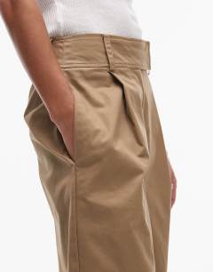 Model wearing Pleated wide leg tailored high waisted chino style trouser in sand