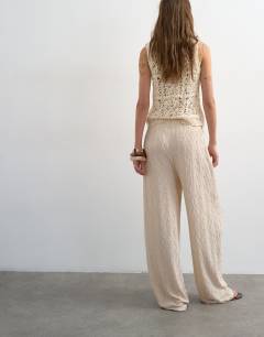 Model wearing Plisse jersey straight leg trousers in stone