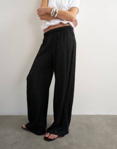 Model wearing Plisse jersey wide leg trouser in black