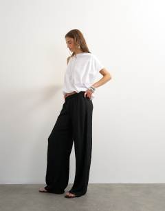 Model wearing Plisse jersey wide leg trouser in black