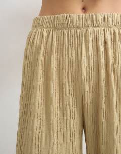 Model wearing Plisse jersey wide leg trouser in khaki