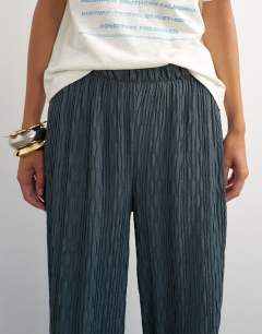 Model wearing Plisse jersey wide leg trouser in slate