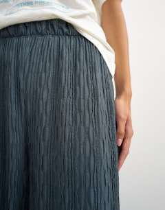 Model wearing Plisse jersey wide leg trouser in slate