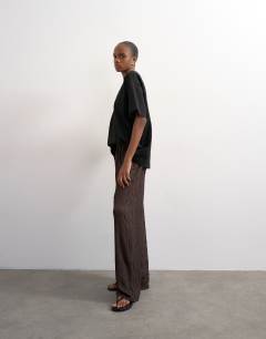 Model wearing Plisse jersey wide leg trousers in chocolate