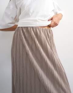 Model wearing Plisse maxi skirt in oat