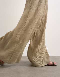 Model wearing Plisse straight leg trouser in beige