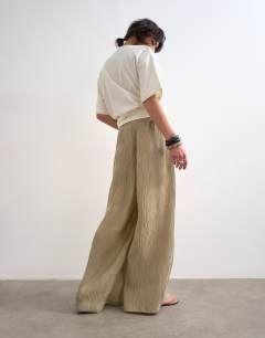 Model wearing Plisse straight leg trouser in beige