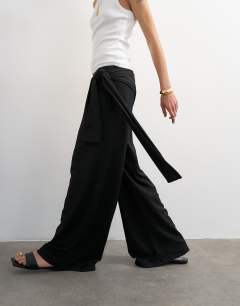 Model wearing Plisse wrap scarf detail trousers in black
