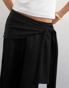 Model wearing Plisse wrap scarf detail trousers in black