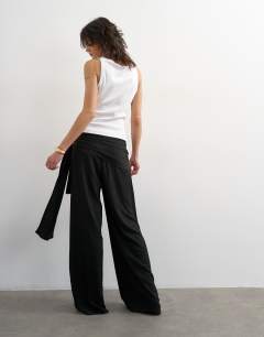 Model wearing Plisse wrap scarf detail trousers in black