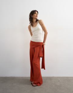 Model wearing Plisse wrap scarf detail trousers in rust