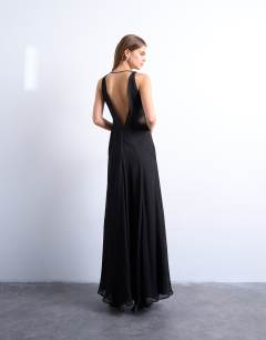 Model wearing Plunge full hem occasion dress with sheer panels in black
