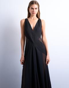 Model wearing Plunge full hem occasion dress with sheer panels in black
