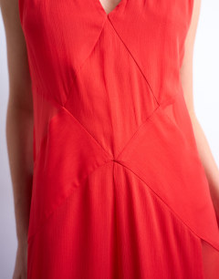 Model wearing Plunge full hem occasion dress with sheer panels in red
