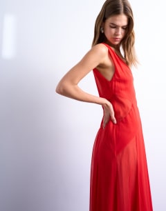 Model wearing Plunge full hem occasion dress with sheer panels in red