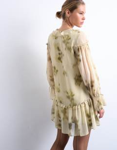 Model wearing Poet sleeve frill mini dress in green floral print