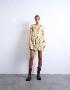 Model wearing Poet sleeve frill mini dress in green floral print
