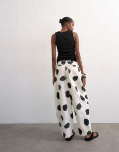 Model wearing Polka dot barrel leg trouser in multi