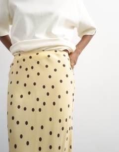 Model wearing Polka dot flood length satin bias maxi skirt in buttermilk