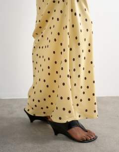 Model wearing Polka dot flood length satin bias maxi skirt in buttermilk