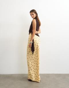 Model wearing Polka dot flood length satin bias maxi skirt in buttermilk