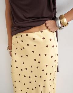 Model wearing Polka dot flood length satin bias maxi skirt in buttermilk