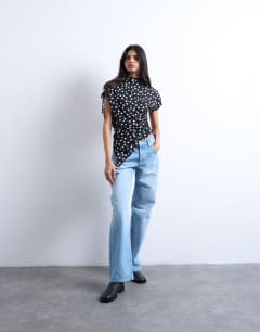 Model wearing Polka dot print asymmetric ruched top in black