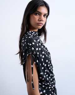 Model wearing Polka dot print asymmetric ruched top in black