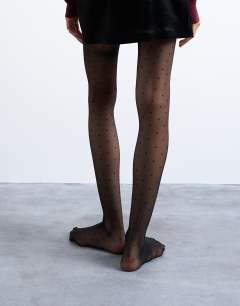 Model wearing Polka dot tights in black