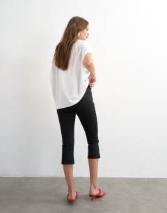 Model wearing Ponte capri leggings in black