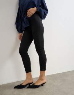 Model wearing Ponte cropped split hem leggings in black