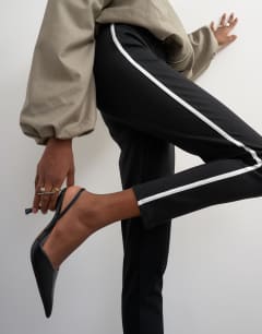 Model wearing Ponte long piping detail leggings in black