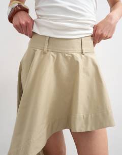 Model wearing Poplin asymmetric mini skirt in stone