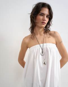 Model wearing Poplin bandeau super dropped waist maxi dress in white