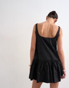 Model wearing Poplin dropped waist square neck mini dress in black