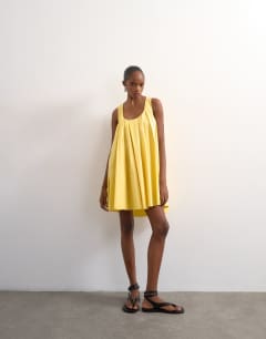 Model wearing Poplin full hem pleated mini sundress in lemon