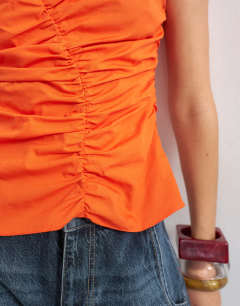 Model wearing Poplin gathered tank top in orange