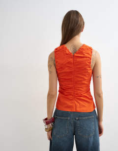 Model wearing Poplin gathered tank top in orange