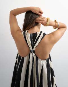 Model wearing Poplin halter deep hem mini trapeze dress in mono stripe