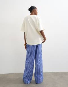 Model wearing Poplin pull on wide leg trouser in dark blue stripe