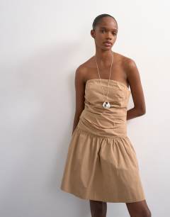 Model wearing Poplin ruched bandeau mini dress in taupe