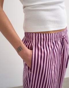 Model wearing Poplin stripe wide leg pull on trouser in pink stripe